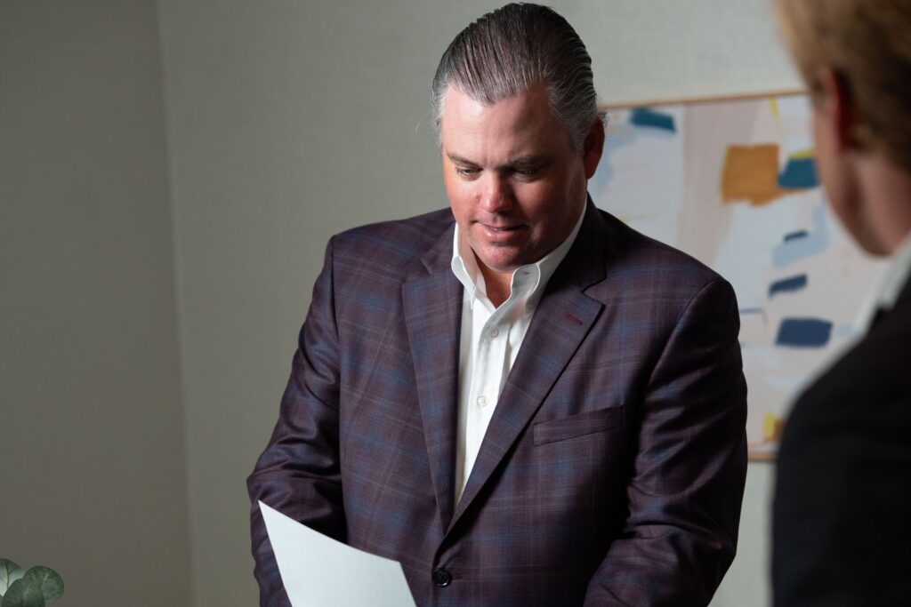 Practice Transitions Group advisor reviewing practice sale documents with a client