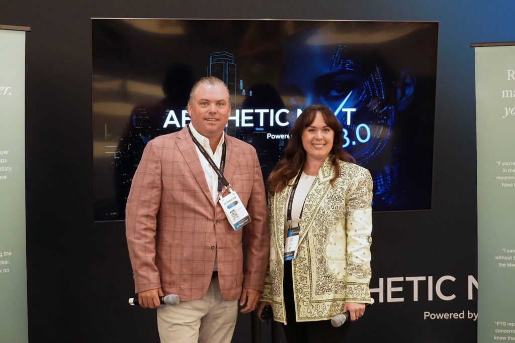 Thomas Allen and Lauren Wheeler of Practice Transitions Group holding microphones in front of an Aesthetic Next 8.0 screen in Dallas