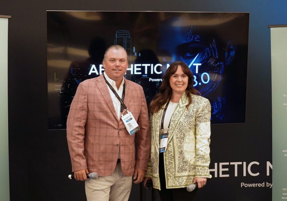 Thomas Allen and Lauren Wheeler of Practice Transitions Group holding microphones in front of an Aesthetic Next 8.0 screen in Dallas